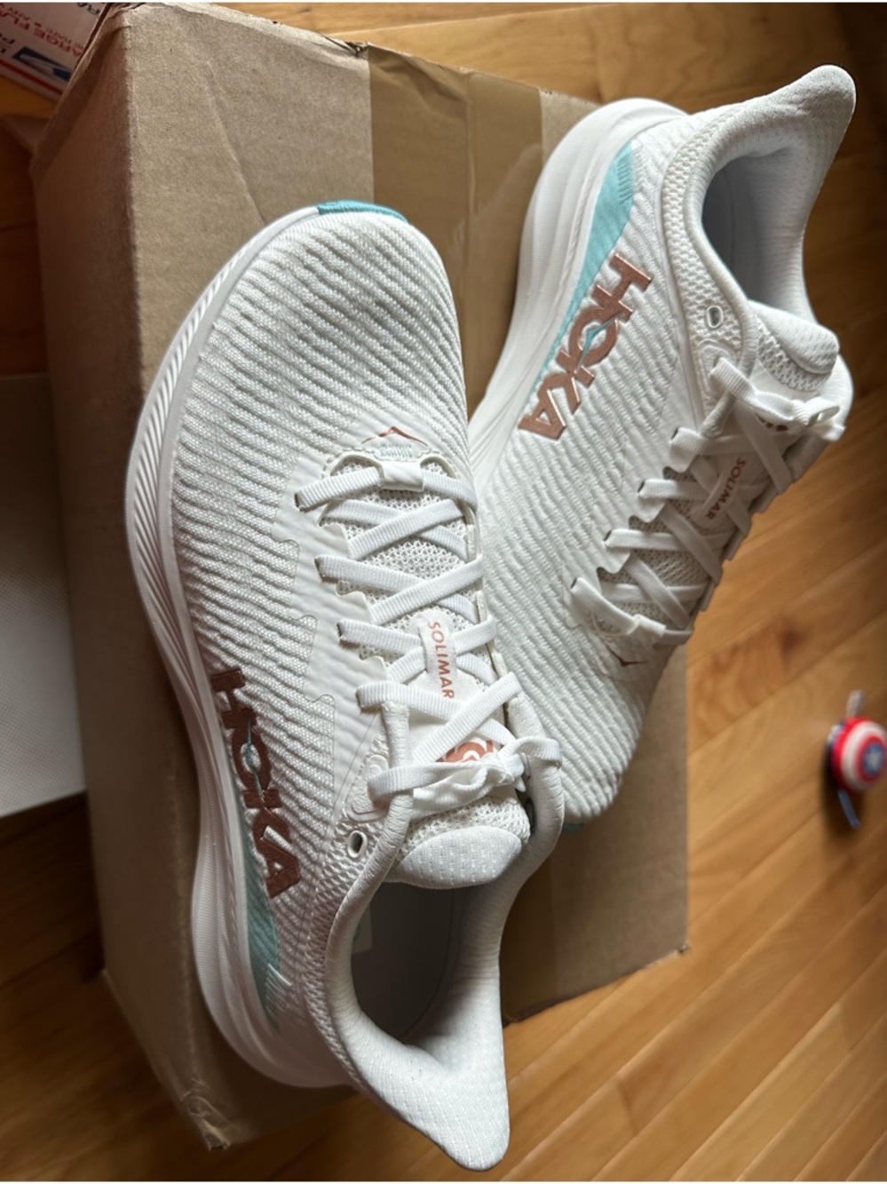 Hoka Women’s White Running Shoes with Rose Gold Logo and Mint Accent